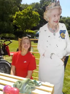 Student with cardboard cutout of Queen celebrating jubilee
