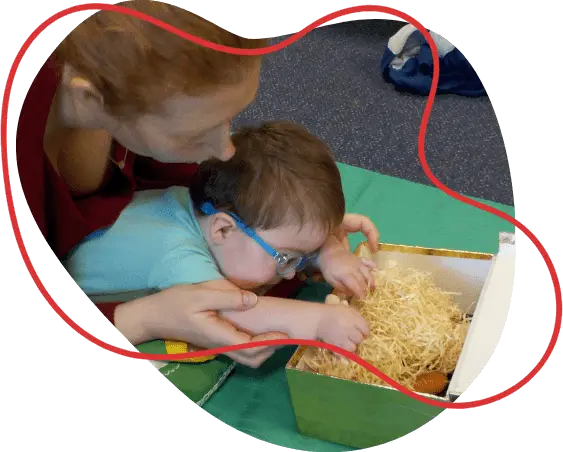 Young child being supported to play